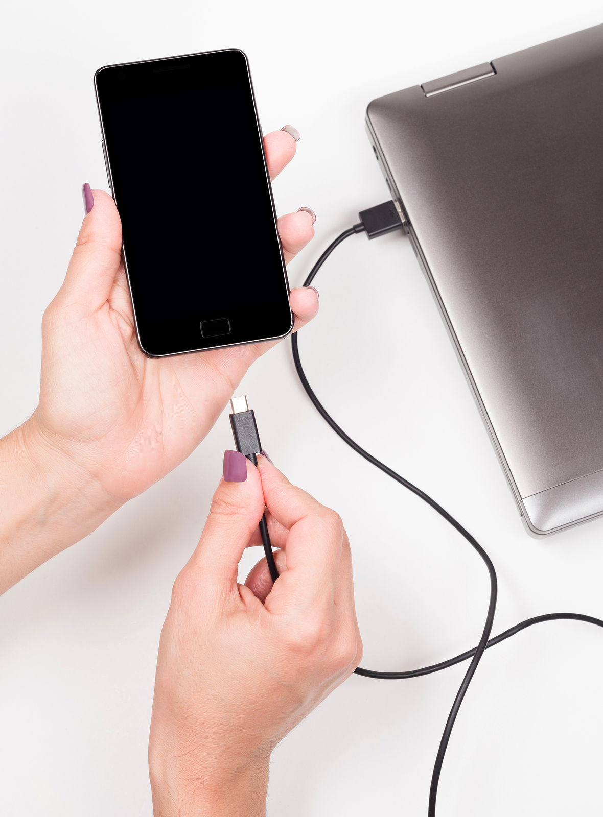 portable battery charger Woman Connecting Smartphone To A Notebook For Powering